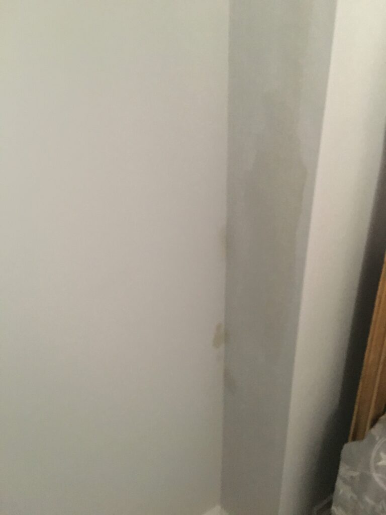 Moisture staining on wall caused by leaking chimney stack
